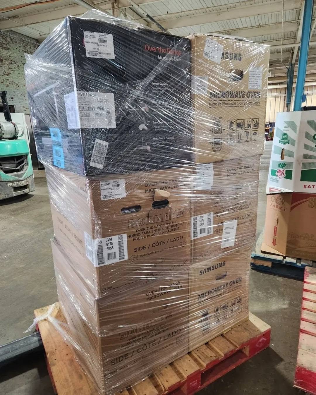 Employee organizing pallets in a storage area
